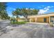 Charming carport and driveway featuring mature landscaping in a well-maintained neighborhood at 208 Sonora Drive # 208, Casselberry, FL 32707