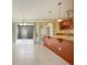 Inviting kitchen with stone countertops, wood cabinetry, and open access to the dining area at 208 Sonora Drive # 208, Casselberry, FL 32707