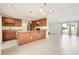 Well-appointed kitchen featuring stone countertops, wood cabinets, and modern appliances at 208 Sonora Drive # 208, Casselberry, FL 32707