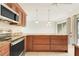 Bright kitchen featuring granite counters, wood cabinets and stainless appliances, with rear lanai at 208 Sonora Drive # 208, Casselberry, FL 32707