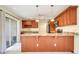 Kitchen with wood cabinets, granite counters and bar with wood trim, opening to rear porch at 208 Sonora Drive # 208, Casselberry, FL 32707