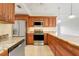 Charming kitchen featuring wood cabinets, granite counters, stainless appliances, and plenty of storage at 208 Sonora Drive # 208, Casselberry, FL 32707