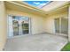 Exterior lanai with sliding glass door entrance and garden view at 208 Sonora Drive # 208, Casselberry, FL 32707