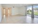 Bright living room featuring tile flooring and sliding glass doors that lead to the outside at 208 Sonora Drive # 208, Casselberry, FL 32707