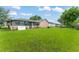 Spacious backyard with lush green grass and mature trees, ideal for outdoor activities at 2309 Cilantro Dr, Orlando, FL 32837