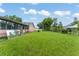 Spacious backyard with lush green grass and mature trees, perfect for outdoor activities at 2309 Cilantro Dr, Orlando, FL 32837
