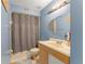 Bathroom with a shower/tub combo, blue walls, and a light wood vanity at 2309 Cilantro Dr, Orlando, FL 32837