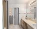 Bathroom with double sinks, vanity, tiled floors, and gray accent paint, offering a practical and functional space at 2309 Cilantro Dr, Orlando, FL 32837