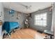 Bedroom with wood floor, ceiling fan, natural light and wall decorations at 2309 Cilantro Dr, Orlando, FL 32837