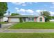 Exterior shot of home with manicured front lawn and attached two car garage at 2309 Cilantro Dr, Orlando, FL 32837