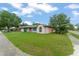 A quaint single-story house with lush green lawn and charming pink exterior nestled in a quiet, tree-lined neighborhood at 2309 Cilantro Dr, Orlando, FL 32837