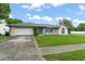 A well-maintained home with an attached garage and a front lawn at 2309 Cilantro Dr, Orlando, FL 32837