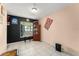 An additional living space featuring black and peach walls, a tiled floor, and a large window with natural light at 2309 Cilantro Dr, Orlando, FL 32837