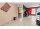 Open-concept living area with sleek tile flooring, adjoining the living room with media center, and a comfortable bedroom at 2309 Cilantro Dr, Orlando, FL 32837