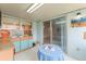 Bright sunroom with tile flooring, and storage cabinets with turquoise doors at 2309 Cilantro Dr, Orlando, FL 32837