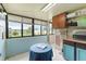 Bright sunroom with tile flooring, large windows overlooking the backyard, and storage cabinets at 2309 Cilantro Dr, Orlando, FL 32837