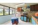 Bright sunroom with tile flooring, large windows overlooking the backyard, and storage cabinets at 2309 Cilantro Dr, Orlando, FL 32837