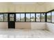 Enclosed sunroom showcasing tile flooring and large windows offering backyard views at 2309 Cilantro Dr, Orlando, FL 32837
