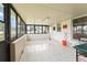 Spacious sunroom features white tile flooring and multiple windows providing natural light at 2309 Cilantro Dr, Orlando, FL 32837