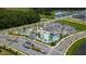 Aerial view of a community amenity center, featuring multiple pools, lounge areas, and cabanas at 2460 Reading Trl, Kissimmee, FL 34746
