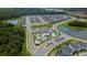 A high aerial view shows a community with ponds, many homes, and a pool/amenity center at 2460 Reading Trl, Kissimmee, FL 34746