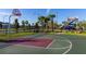 Outdoor basketball court and playground with palm trees in a well-maintained community at 2460 Reading Trl, Kissimmee, FL 34746