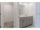 Bathroom featuring double vanity with white countertops and gray cabinets, providing ample storage space at 2460 Reading Trl, Kissimmee, FL 34746