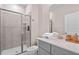 Bathroom with a glass door shower, gray vanity with neutral countertops and a white toilet at 2460 Reading Trl, Kissimmee, FL 34746