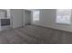 This spacious bedroom features neutral carpet, closet, and abundant natural light from two windows at 2460 Reading Trl, Kissimmee, FL 34746