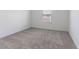 Neutral carpet and white walls create a clean, bright, and versatile space in this bedroom at 2460 Reading Trl, Kissimmee, FL 34746
