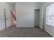 Bright bedroom with neutral carpet, closet, and natural light from a large window and an open doorway at 2460 Reading Trl, Kissimmee, FL 34746
