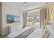 Inviting bedroom with a large TV, neutral tones and natural lighting at 2460 Reading Trl, Kissimmee, FL 34746