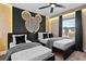 A third view of the fun themed bedroom featuring two twin beds, dark wood furniture and Mickey Mouse accent wall at 2460 Reading Trl, Kissimmee, FL 34746