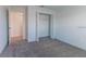 Bright bedroom features neutral carpet, white walls, closet and doorway, creating a serene, versatile space at 2460 Reading Trl, Kissimmee, FL 34746