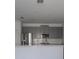Well-lit kitchen featuring gray cabinets, stainless steel appliances, and a breakfast bar at 2460 Reading Trl, Kissimmee, FL 34746