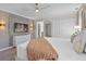 Beautiful primary bedroom featuring a soft color palette, mounted TV, and ensuite bathroom at 2460 Reading Trl, Kissimmee, FL 34746