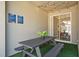 Covered patio with outdoor dining area, artificial turf and string lights for ambiance at 2460 Reading Trl, Kissimmee, FL 34746