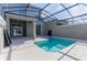 This backyard features a private pool with a screened enclosure and a spacious patio area at 2460 Reading Trl, Kissimmee, FL 34746