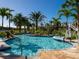A community lazy river pool with a convenient chair lift and tropical landscaping at 2460 Reading Trl, Kissimmee, FL 34746