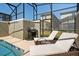Pool with poolside lounge chairs and grill at 2460 Reading Trl, Kissimmee, FL 34746