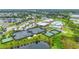 Aerial view of a community featuring tennis courts, a putting green, and multiple ponds at 2571 Yellow Brick Rd, St Cloud, FL 34772