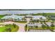 An aerial view showcases the community's clubhouse, pool, and beautiful lake at 2571 Yellow Brick Rd, St Cloud, FL 34772