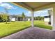 View from covered patio overlooking manicured backyard and neighboring homes at 2571 Yellow Brick Rd, St Cloud, FL 34772