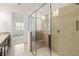 Spa-like bathroom featuring glass shower with seat, tile surround and view to bedroom at 2571 Yellow Brick Rd, St Cloud, FL 34772