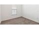 Cozy bedroom with neutral carpet, a window with blinds, and fresh, white trim at 2571 Yellow Brick Rd, St Cloud, FL 34772