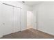 This bedroom features a closet with double doors and light brown carpeting at 2571 Yellow Brick Rd, St Cloud, FL 34772