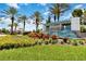 The Twin Lakes community entrance is beautifully landscaped with colorful flowers and palm trees at 2571 Yellow Brick Rd, St Cloud, FL 34772