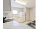Bright eat-in kitchen with white cabinets, countertops, appliances, and a stainless-steel sink at 2816 Club Cortile Cir # A, Kissimmee, FL 34746