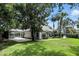 Spacious backyard with lush lawn and a screened-in pool, perfect for outdoor living at 2890 Wild Ginger Ct, Winter Park, FL 32792