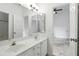 Well-lit bathroom with a double sink vanity, a large mirror, and white cabinetry at 2890 Wild Ginger Ct, Winter Park, FL 32792